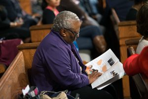 A woman sits before a town hall meeting sponsored by Georgia Charter Schools Association and GeorgiaCAN at Ebenezer Baptist Church on Friday, Jan. 13, 2017, in Atlanta. (Branden Camp/AP Images for Georgia Charter Schools Association)